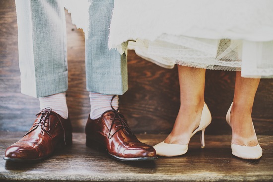 Man and women 's feet standing next to each other