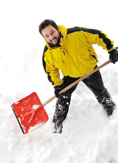 Man shovelling snow with proper technique to avoid back pain