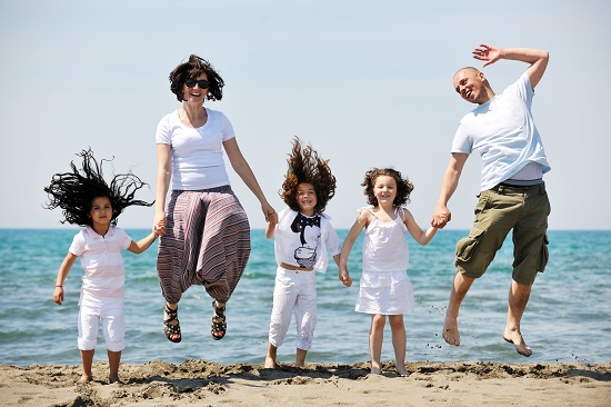 happy young family have fun and live healthy lifestyle on beach